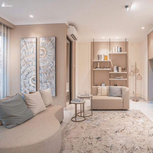 Modern living room with curved sofas, built-in shelving, soft neutral tones, and flexible seating that supports practical daily living.