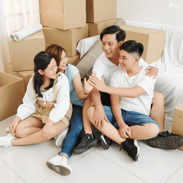 Family sitting together among moving boxes while helping children feel comfortable and connected in a new home.