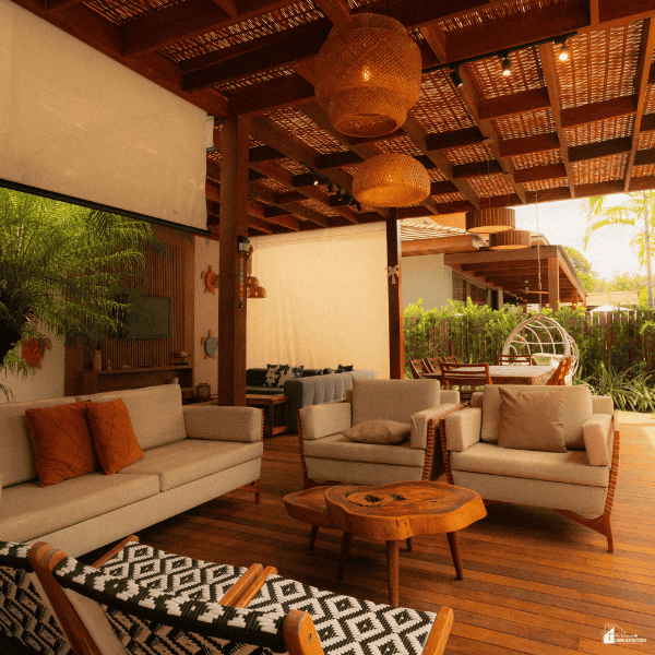 Cozy covered patio with soft seating, warm lighting, and natural wood details creating an inviting outdoor living space.