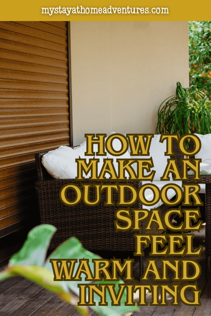 Small patio seating area with woven furniture and plants arranged to create a warm and welcoming outdoor space.