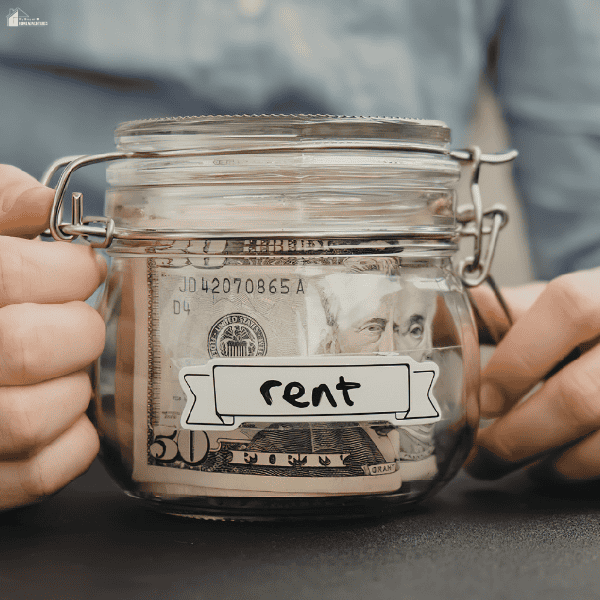 Glass jar filled with cash to represent budgeting strategies and saving money for monthly housing expenses.