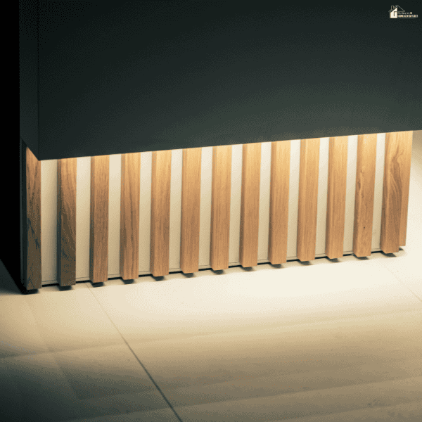 Modern wood slat panel feature with warm oak tones and clean vertical lines in a minimalist interior space.