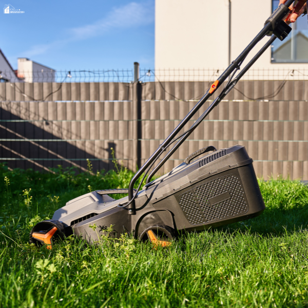 A cordless lawn mower cutting thick grass, showing performance that depends on quality aftermarket mower blades.