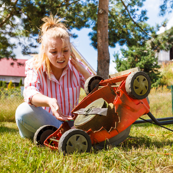 A frustrated woman checking a lawn mower underside, highlighting issues that worn or poor-quality aftermarket mower blades can cause.