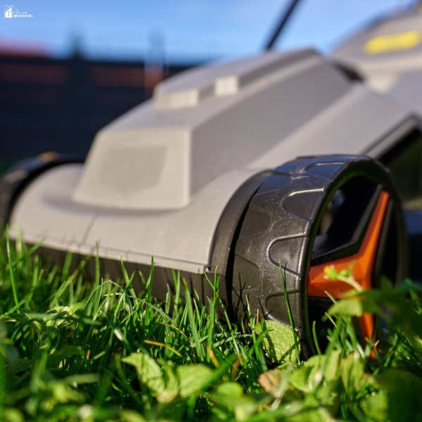 A close-up of a mower moving through grass, emphasizing how sharp aftermarket mower blades improve cutting results.