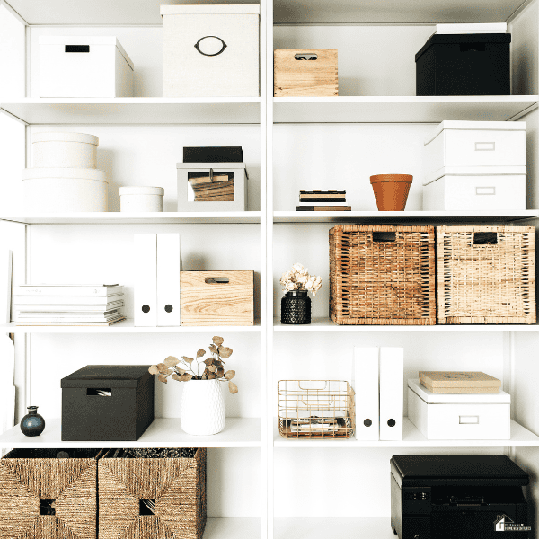 Organized white shelving with baskets, storage boxes, and home essentials arranged neatly to create a clutter-free and functional living space.