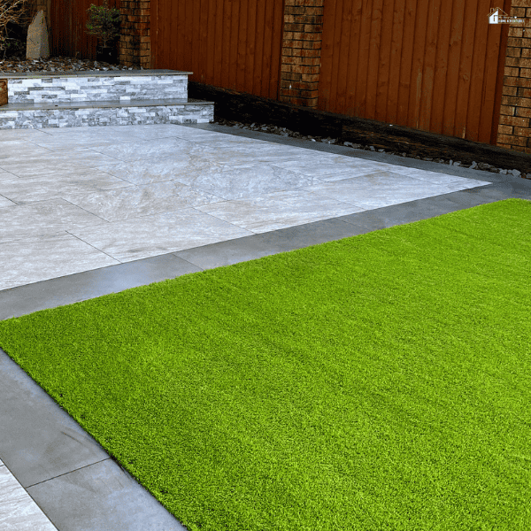 Modern backyard patio with neatly installed synthetic turf designed for low-maintenance outdoor living spaces.