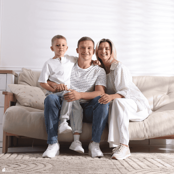 Family relaxing together on a cozy sofa in a bright living room designed for comfort and everyday living.