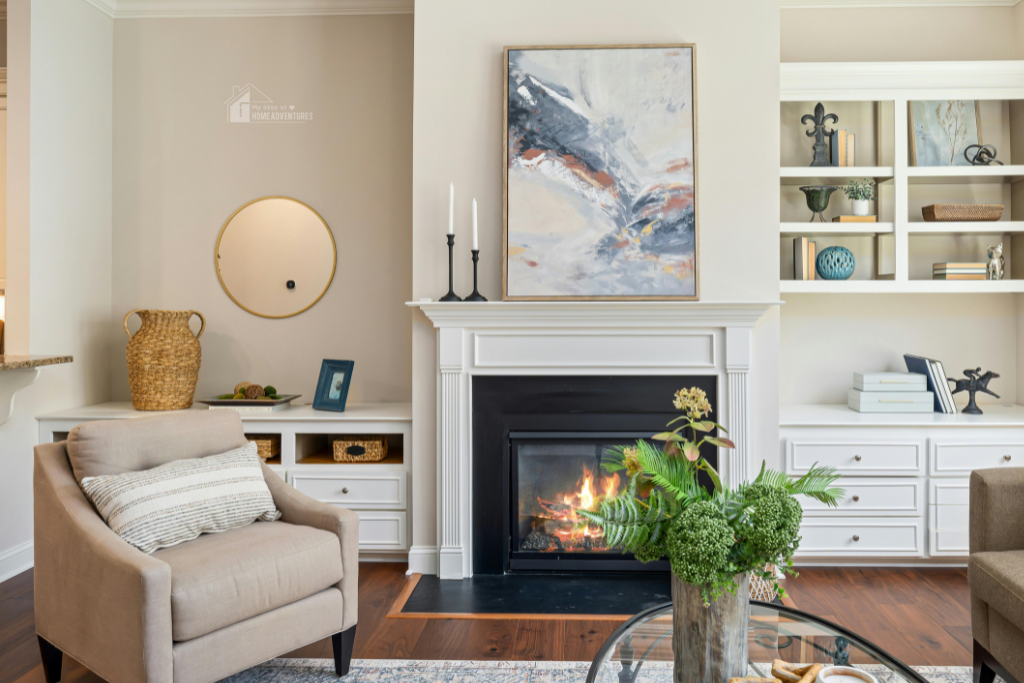 Bright cozy living room with fireplace, neutral decor, built-in shelves, soft armchair, and plants creating a warm and functional family-friendly space