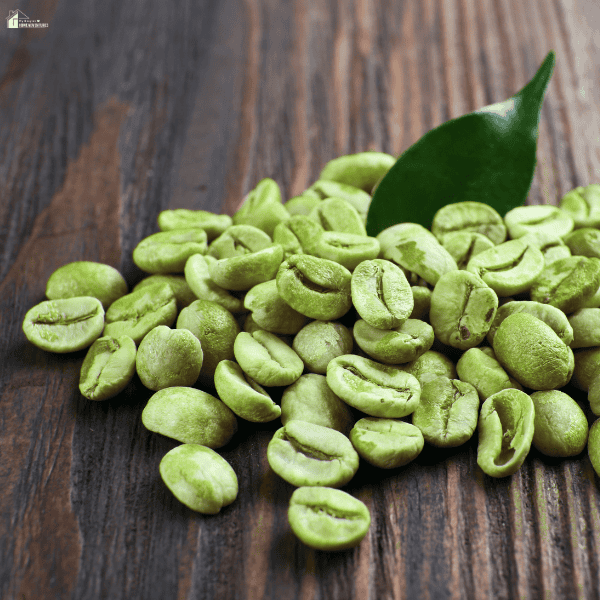 Unroasted green coffee beans on a wooden surface, highlighting the raw ingredients used by specialty coffee suppliers and roasters.