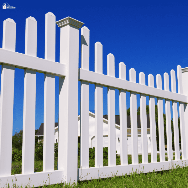 White privacy fence surrounding a residential property, illustrating fence styles homeowners may compare before hiring a fencing contractor.