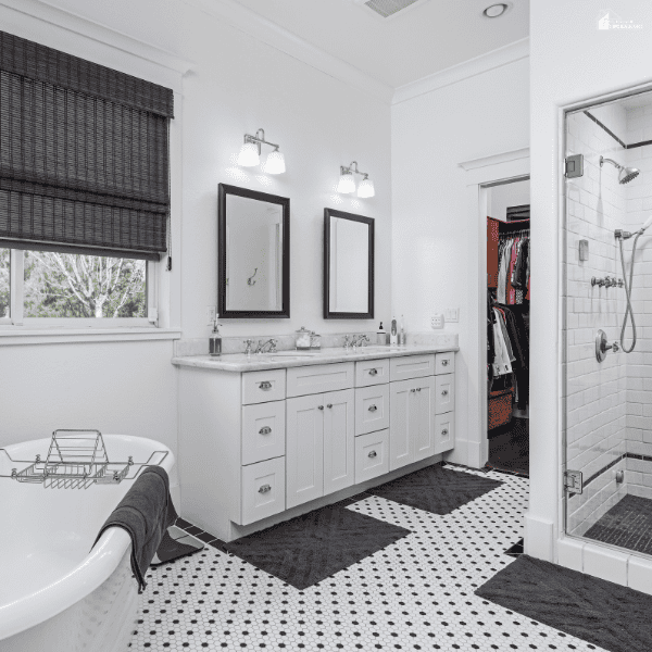 Bright remodeled bathroom featuring a double vanity, freestanding tub, and modern shower enclosure for improved functionality.