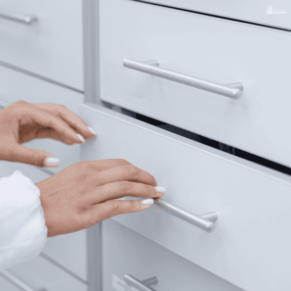 Homeowner opening a cabinet drawer, highlighting storage planning and organization during a home remodeling project.