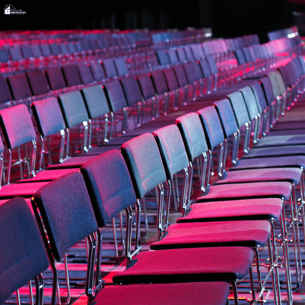 Rows of seating arranged for a large corporate gathering, highlighting the importance of selecting an off-site venue that fits attendance and event requirements.
