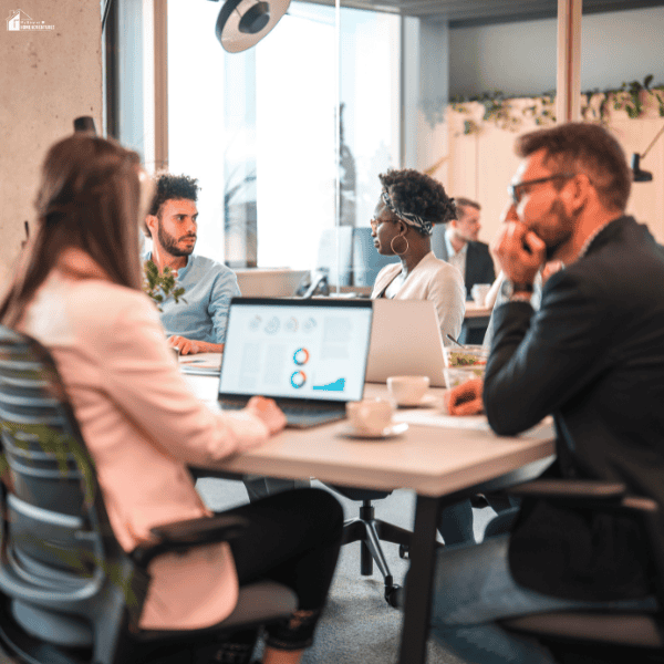 Business professionals discussing digital marketing goals and performance metrics during an SEO agency evaluation meeting.