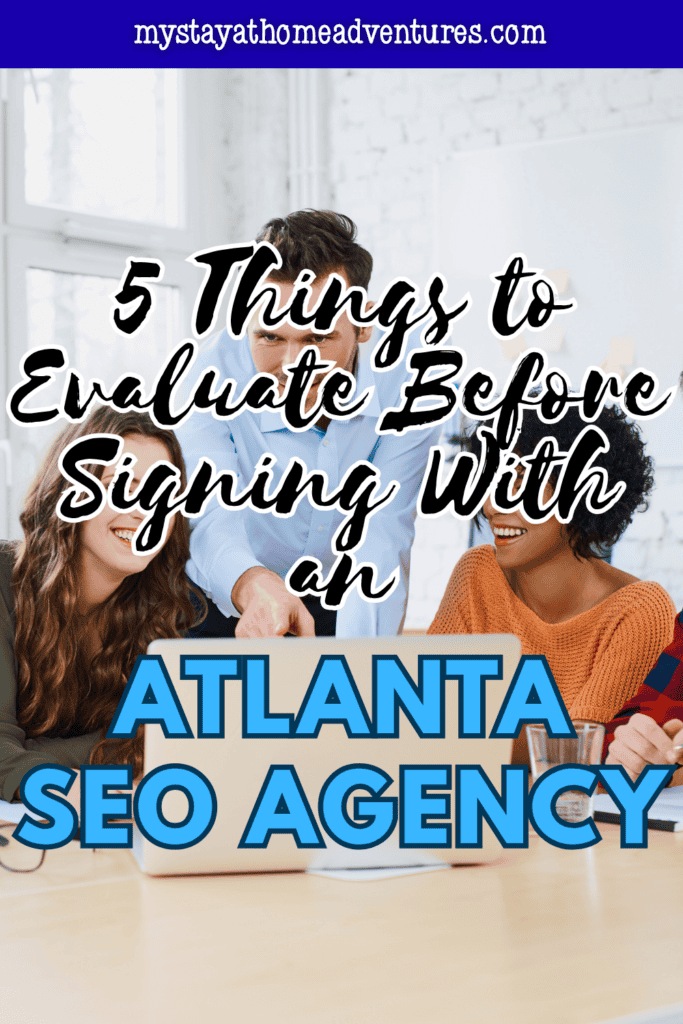 Team collaborating around a laptop to assess digital marketing strategies and choose the right SEO agency for business growth.