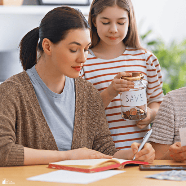 Parent and child reviewing savings goals together, highlighting smart family budgeting habits and long-term financial planning.