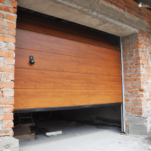 Modern wood-look garage door installed in a brick structure, highlighting material quality, durability, and curb appeal.