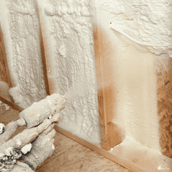 Spray foam insulation being applied inside a wall cavity to seal gaps and improve home comfort and air control.