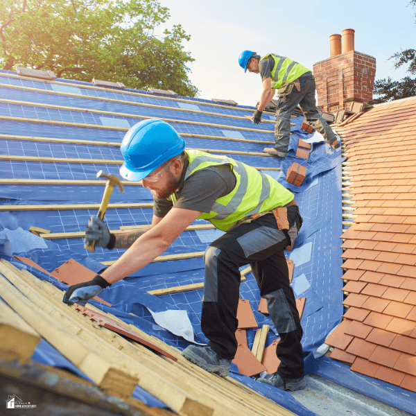 Roofing contractors replacing worn roofing materials on a house to improve protection, energy efficiency, and future repair savings.