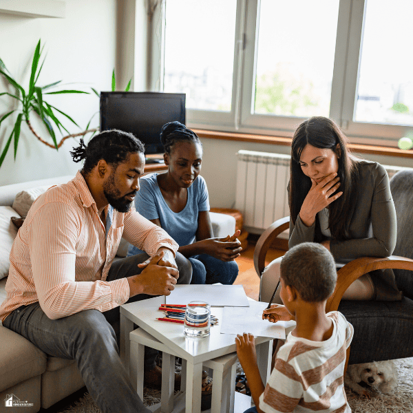 Family meeting with a child and healthcare professional, highlighting health planning and routine coordination around therapy appointments.
