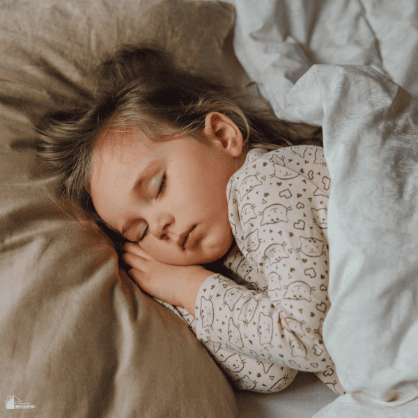 Young child sleeping comfortably in a cozy bedroom designed to support safety, comfort, and healthy sleep habits.