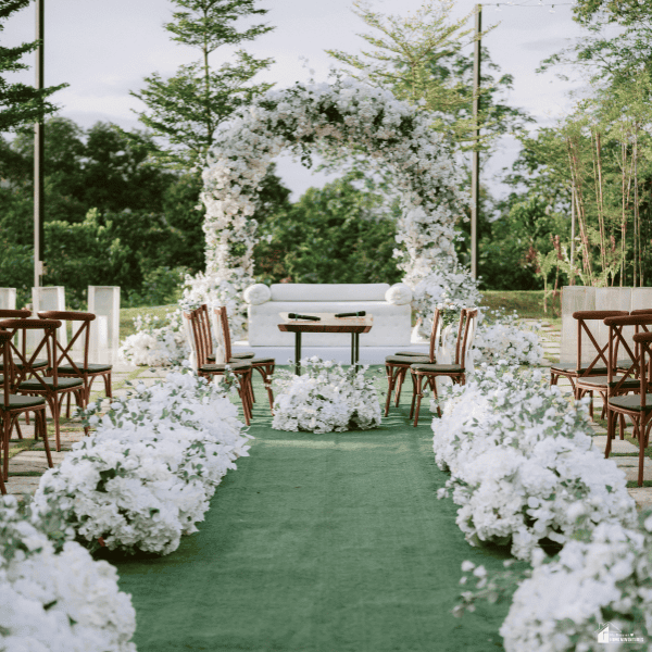 Garden wedding venue featuring lush floral arrangements, ceremony seating, and a beautifully landscaped setting for a special day.