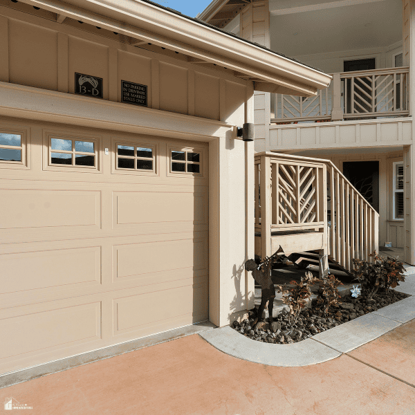 Well-maintained residential garage door attached to a home, highlighting the importance of regular garage door inspection and repair.
