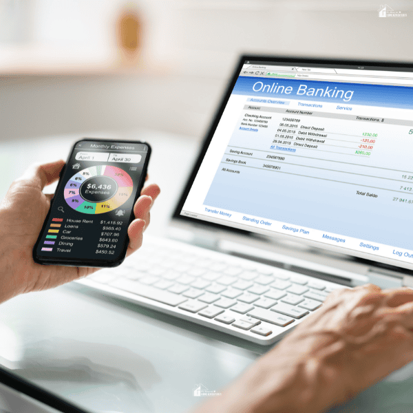 Person reviewing banking information and expense tracking tools to manage spending and monitor a household budget.