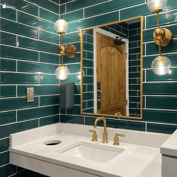 Modern remodeled bathroom featuring stylish tilework, updated lighting, a contemporary vanity, and premium fixtures.