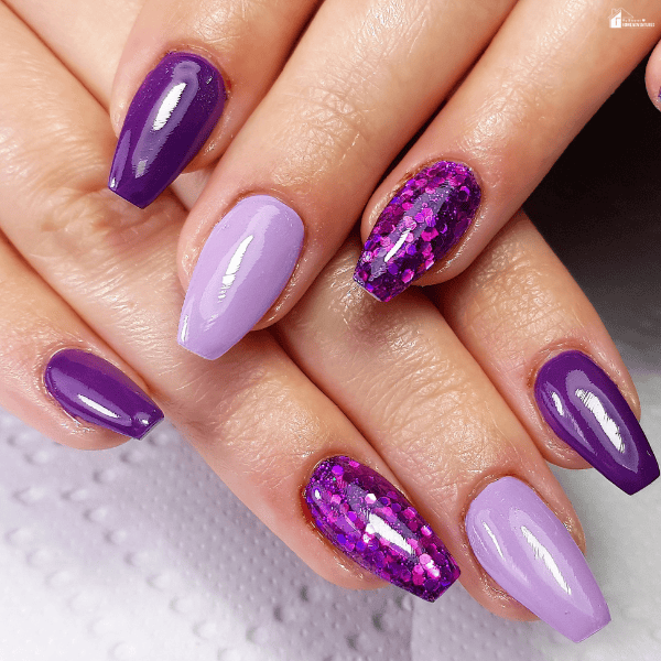 Purple and lavender DIY nail sets with glitter accents applied at home for a long-lasting manicure look.