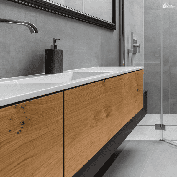 Light wood vanity with a sleek countertop and modern fixtures, showing how natural wood tones complement contemporary bathroom designs.