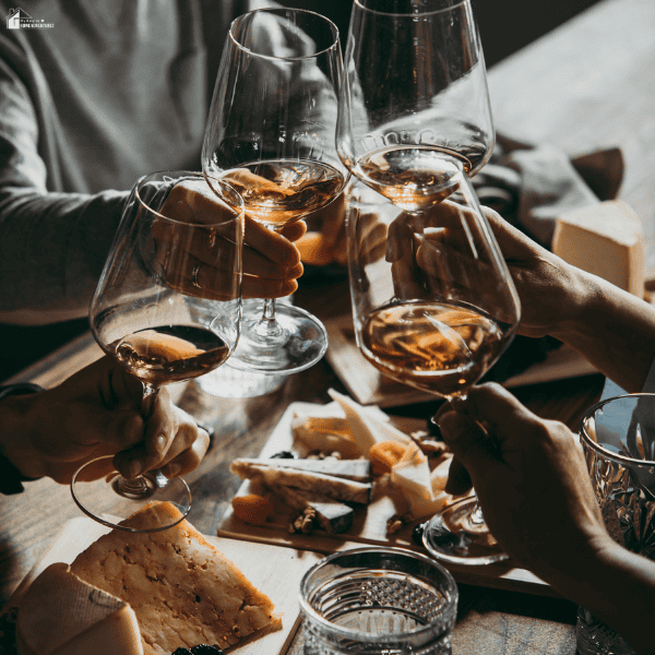 Friends enjoying a wine tasting with local cheeses and regional foods, highlighting a typical winery experience in Slovenia.