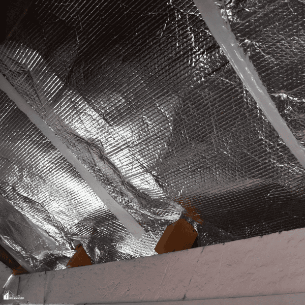 Reflective insulation installed beneath a roof system to control roof heat dynamics and reduce heat transfer into the building.
