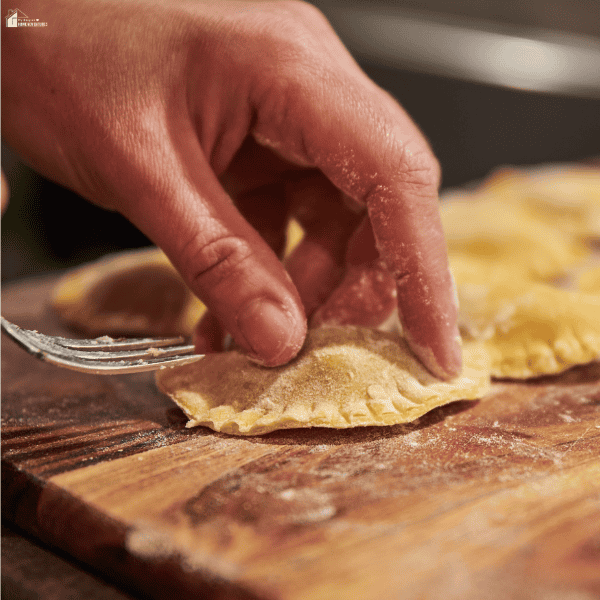 Chef shaping fresh stuffed pasta by hand, illustrating traditional pasta-making techniques and the importance of pasta quality in Italian cuisine.