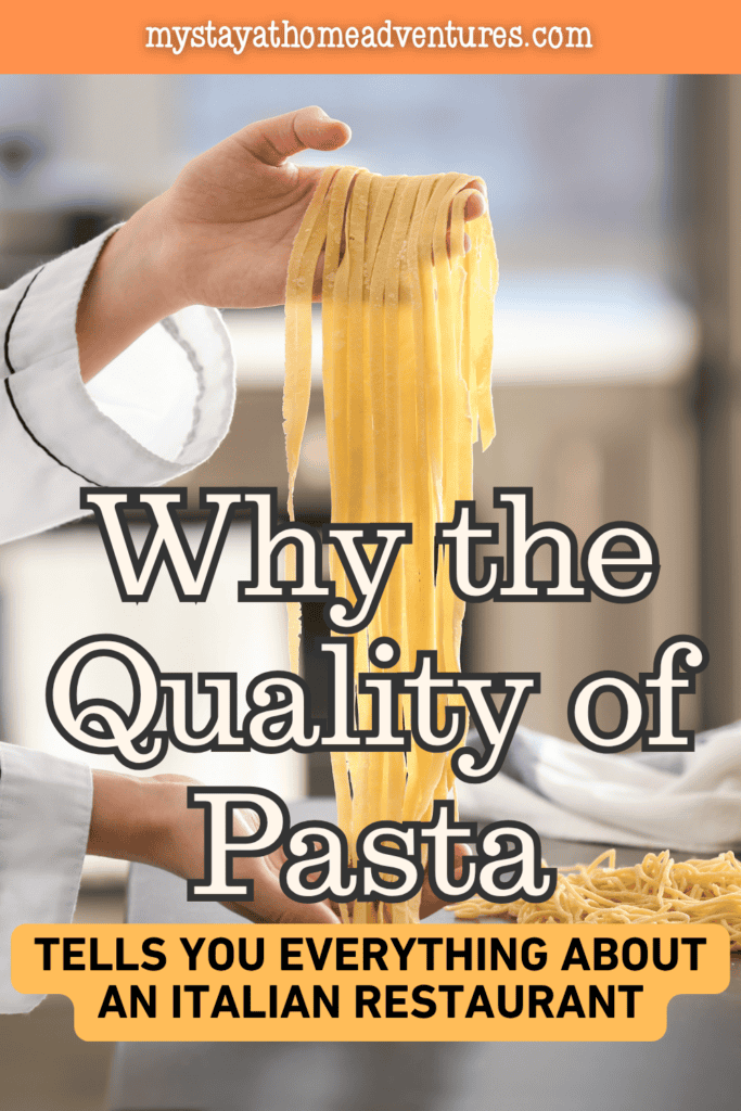 Fresh pasta being held by a chef in a professional kitchen, representing the role of handmade pasta quality in evaluating authentic Italian restaurant experiences.