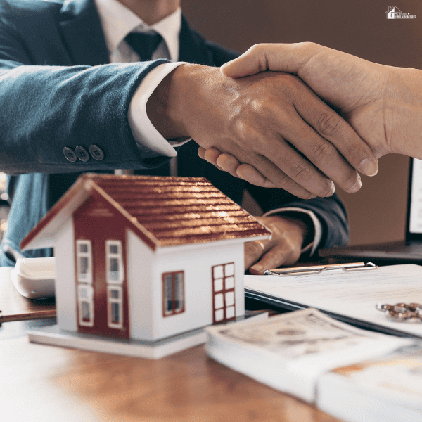 Business professionals shaking hands over a property transaction, symbolizing successful property investment strategies, negotiations, and real estate business principles.