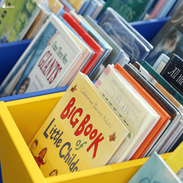 A selection of children's books displayed on shelves highlights practical gifts that encourage learning, reading, and creativity.