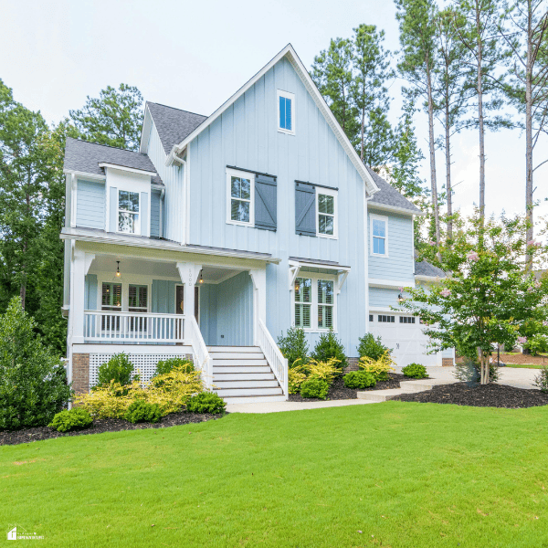 Well-maintained residential lawn surrounding a home, illustrating healthy grass care practices and the importance of proper lawn maintenance.