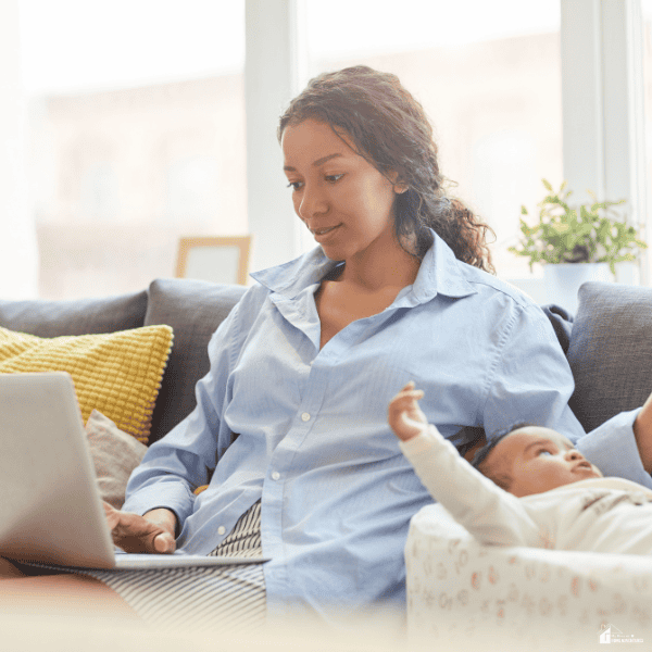 Parent working from home on career growth while balancing childcare responsibilities and professional development.