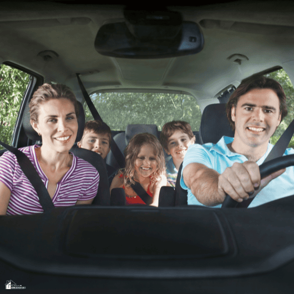 Family enjoying a budget-friendly road trip together in a car, showing affordable travel and memorable family adventures.