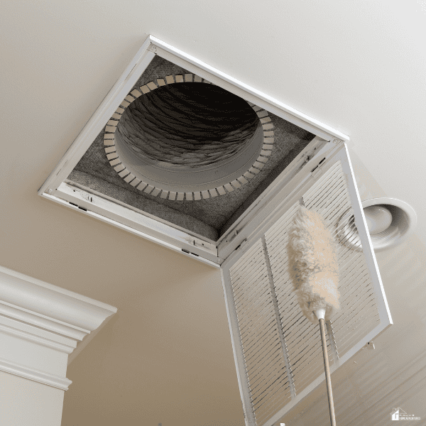 Ceiling air vent being cleaned to improve airflow and help prevent heating and cooling system problems.