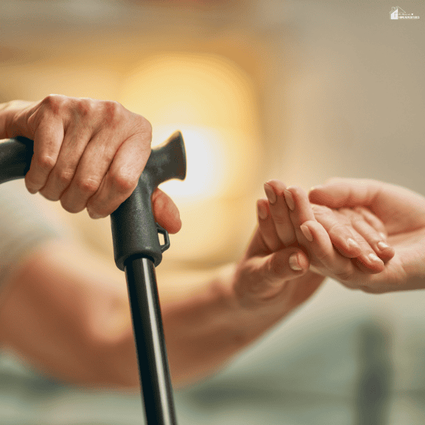 An older adult receives gentle support from a caregiver, representing care and protection for elder abuse victims.