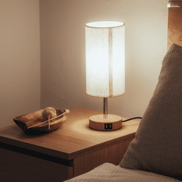 Warm bedside table with a modern lamp and natural wood furniture, demonstrating a simple luxury home upgrade that adds comfort and style.
