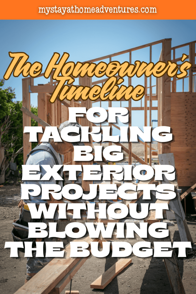 A contractor works on the wooden frame of a new home, representing careful planning and budgeting for large exterior home improvement projects.