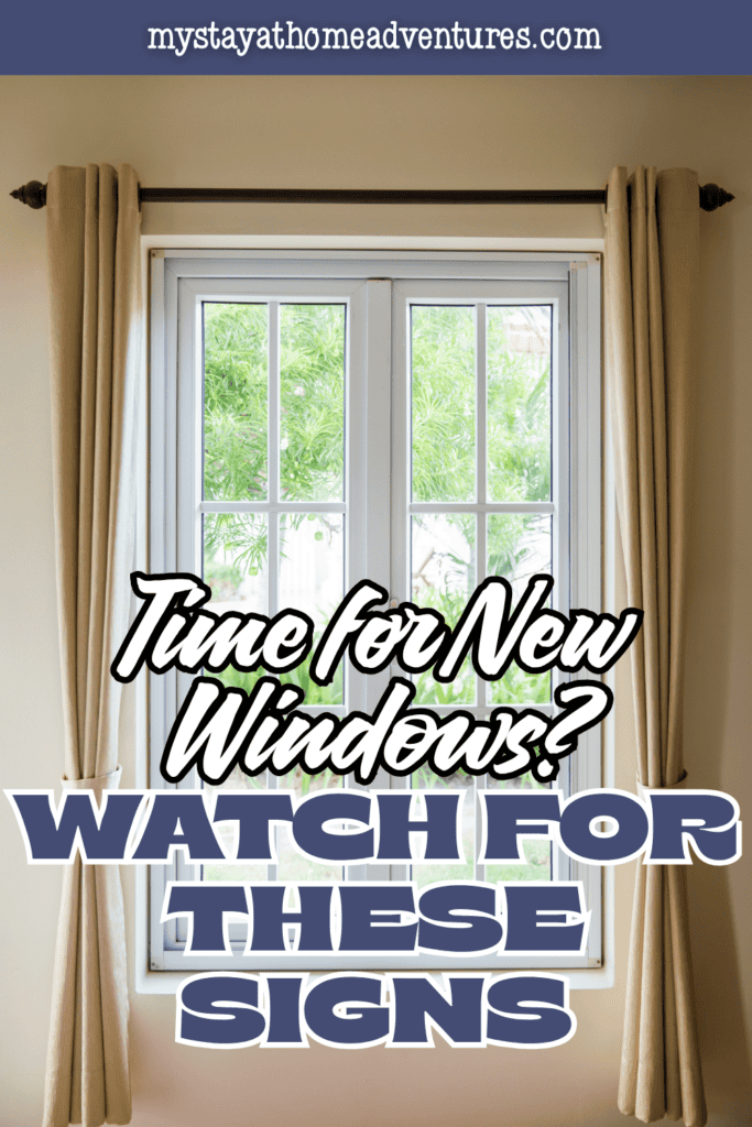 A bright living room features large replacement windows with curtains that enhance natural light and home comfort.