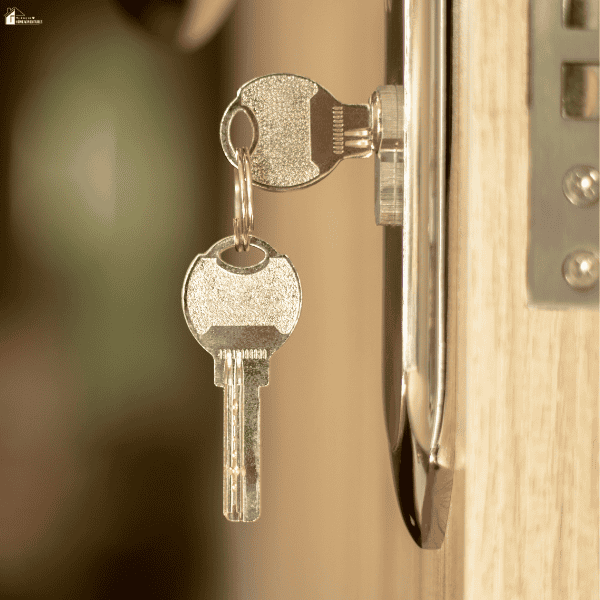 Keys in a front door lock represent secure home access and safe property management for vacation rentals.
