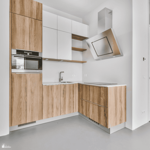 Modern kitchen with wood cabinets and white finishes, showing an updated interior that complements broader home improvement projects.