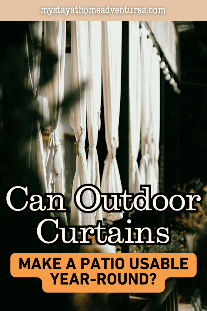 White outdoor curtains tied back along a shaded patio, creating a private and comfortable outdoor living space.