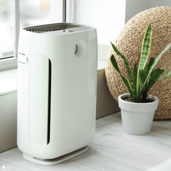A modern air purifier sits near a window, helping improve indoor air quality and create a healthier home environment.